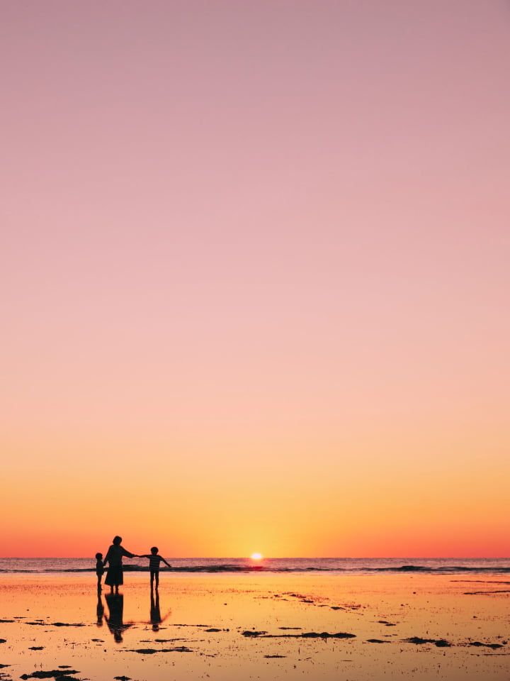 A picture of the sunset over the sea and the surrounding area at sunset.